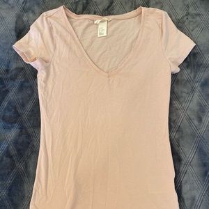 This is a light pink slim fitting v neck